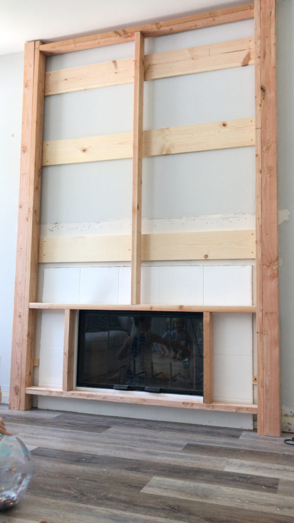 Structure pushed up and secured to the sides of the fireplace build. 