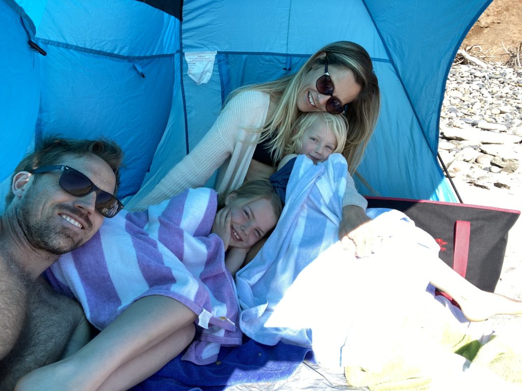 Relaxing with the family under the beach tent