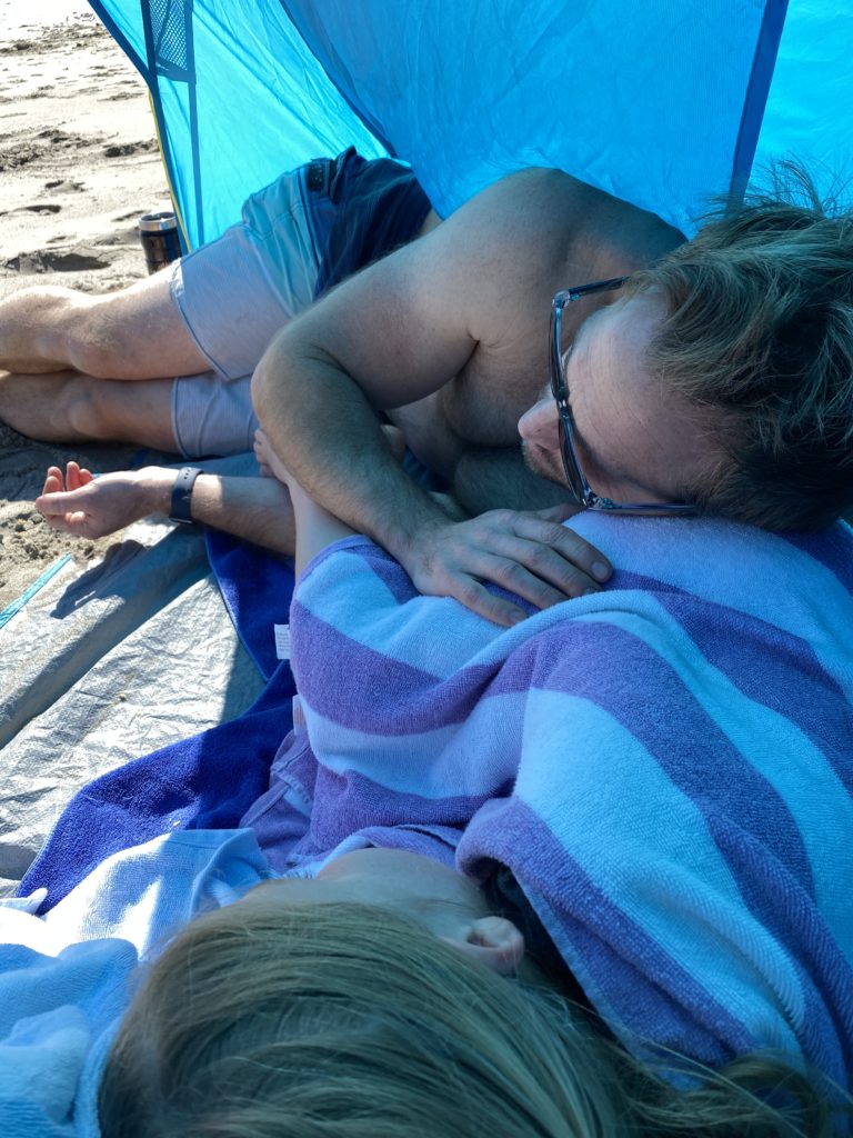 Relaxing with the family under the beach tent