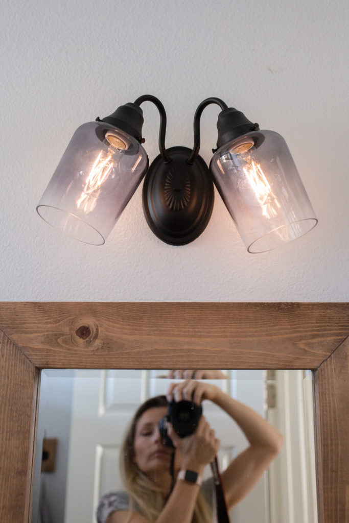 Bathroom makeover - After shot of Vanity light makeover with Matte black spray paint and new glass. 