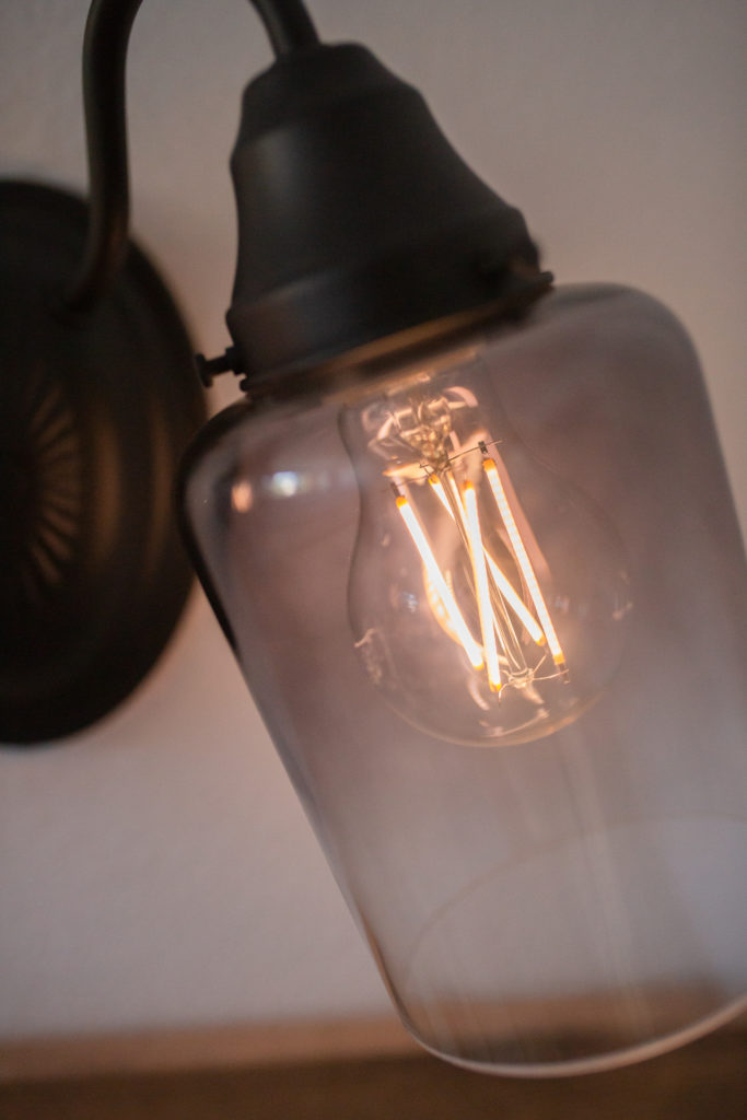 Bathroom makeover - Closeup of new bulb in Vanity light fixture