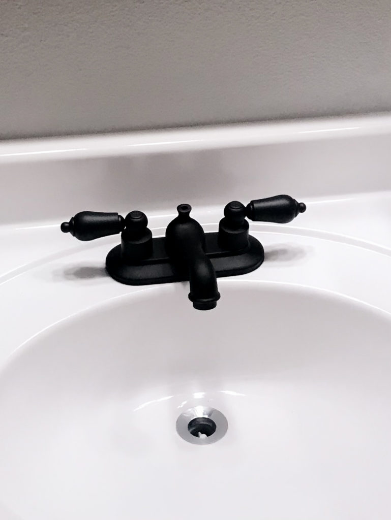 Vanity makeover with white Appliance Epoxy Spray. Bathroom faucet sprayed with matte black spray paint too. 