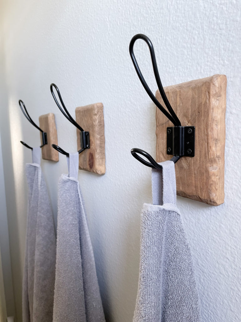 Bathroom makeover - Closeup of Farmhouse Towel Hooks with DIY rustic wood backing