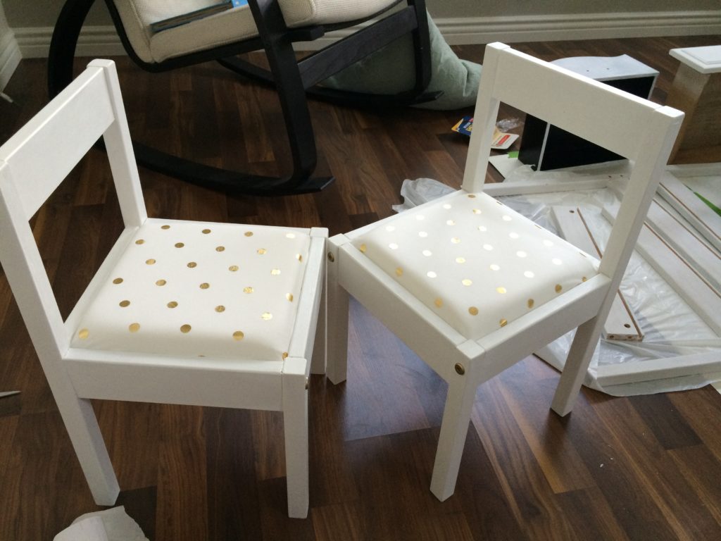 Ikea LATT chair hack with white paint, and white & gold polka dot cushions.