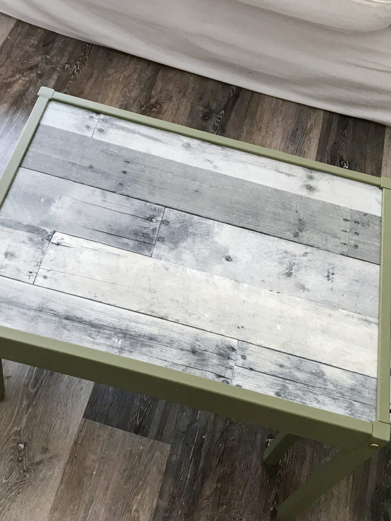 Ikea LATT table with 'Olive Grove' by BM paint and 'wood' wallpaper tabletop.