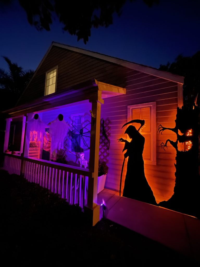 Night view of the DIY Silhouette Decor for halloween - New grim reaper silhouette back lit with orange lights.